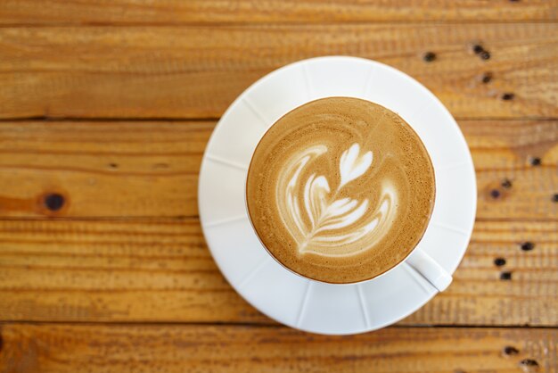 Cup of coffee with latte art pattern milk foam