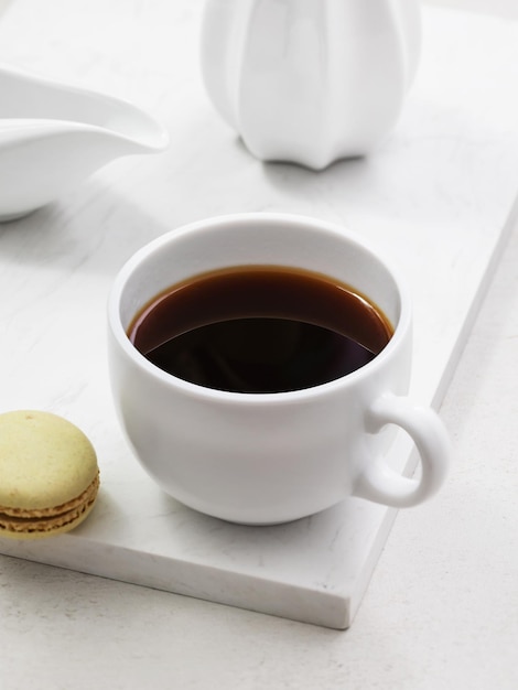 Cup of coffee with macaroons on the table