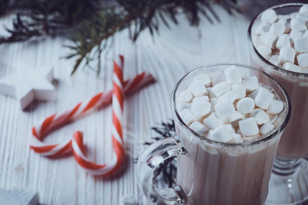 Cup of coffee with marshmallows and candy cane