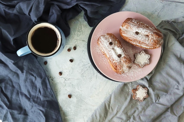 Cup of coffee with marshmallows eclairs and cookies coffee grains