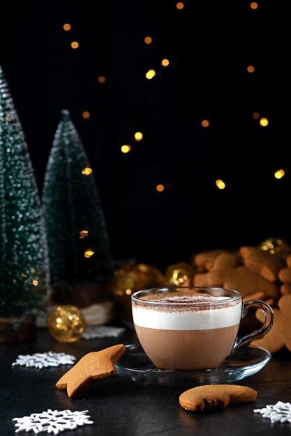 A cup of coffee with milk and gingerbread at Christmas