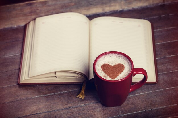 Cup of coffee with notebook