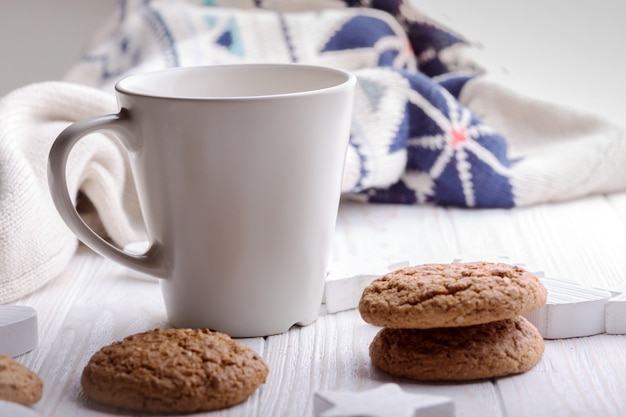 Cup of coffee with oat cookies and Christmas decorations