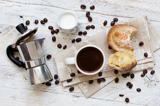 Cup of coffee with pasticciotto pastry on a rustic background close up