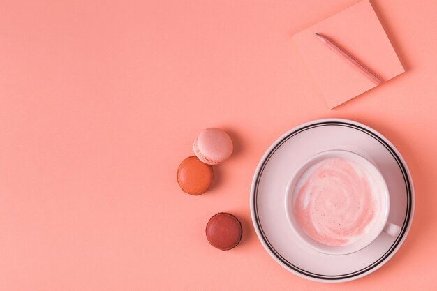 Cup of coffee with sweet macaroons