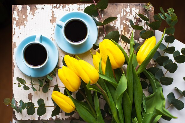 cup of coffee with tulips