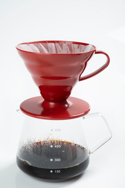 Cup of coffee with a V60 dripper coffee maker isolated over a white background
