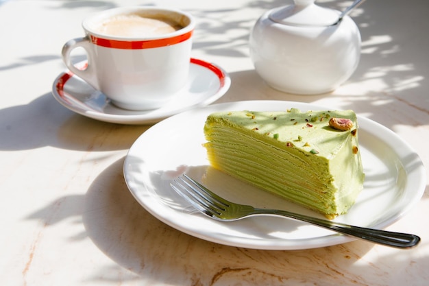 Cup of coffee with vegan pancake pie