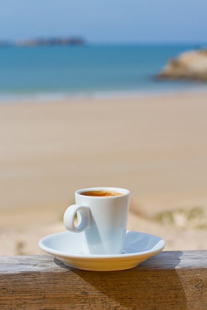 Cup of coffee with view on beach