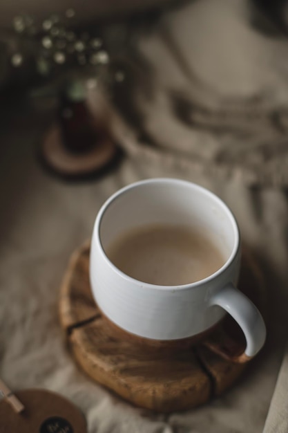 A cup of coffee with a wooden base and a wooden base.