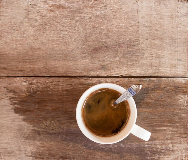 Cup of coffee on a wood table background