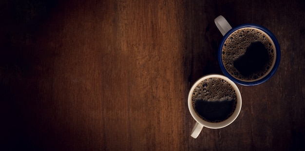 Cup of coffee on wooden background.