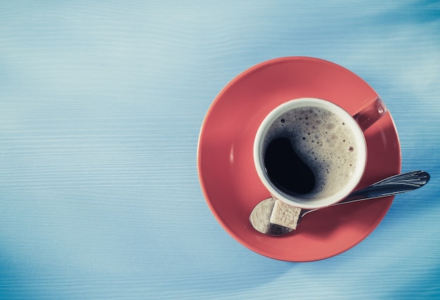 Cup of coffee on wooden surface