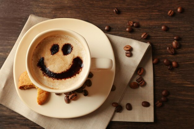 Cup of coffee on wooden table background