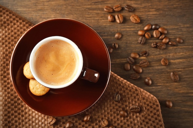 Cup of coffee on wooden table background