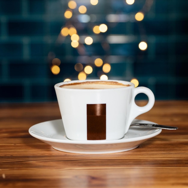 Cup of coffee on wooden table in cafe