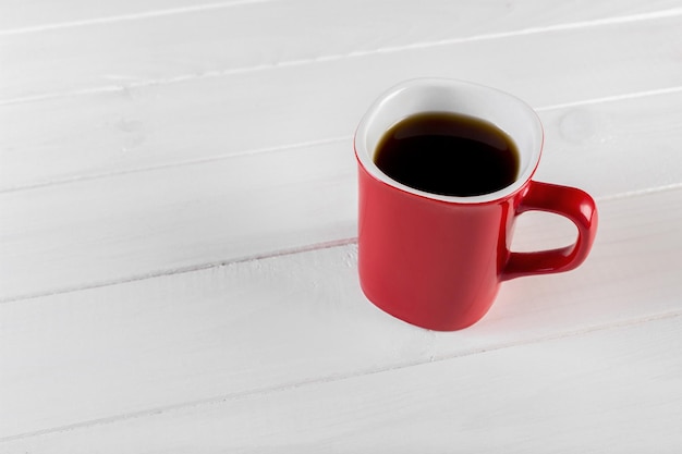 Cup of coffee on wooden table top view