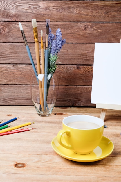 A cup of coffee on a wooden table.