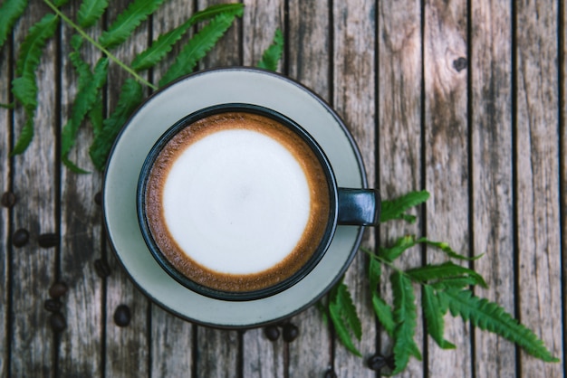 Cup of coffee on wooden table.