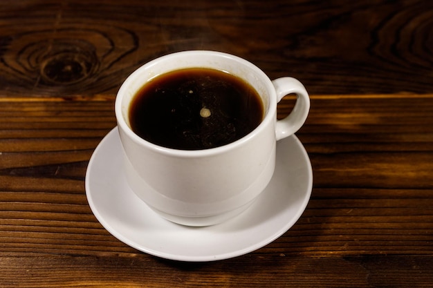 Cup of coffee on the wooden table