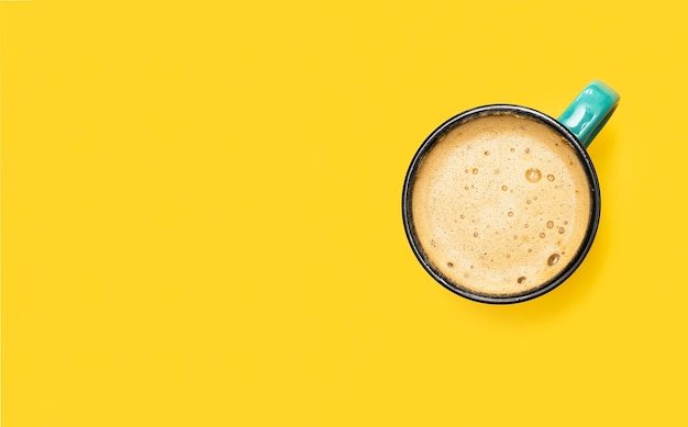 Cup of coffee on a yellow background.