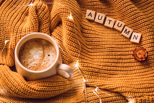 Cup of coffee and yellow sweater.