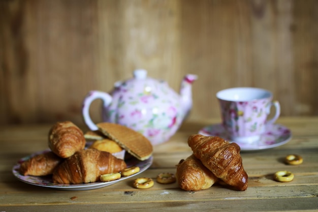 Cup croissant breakfast wooden background