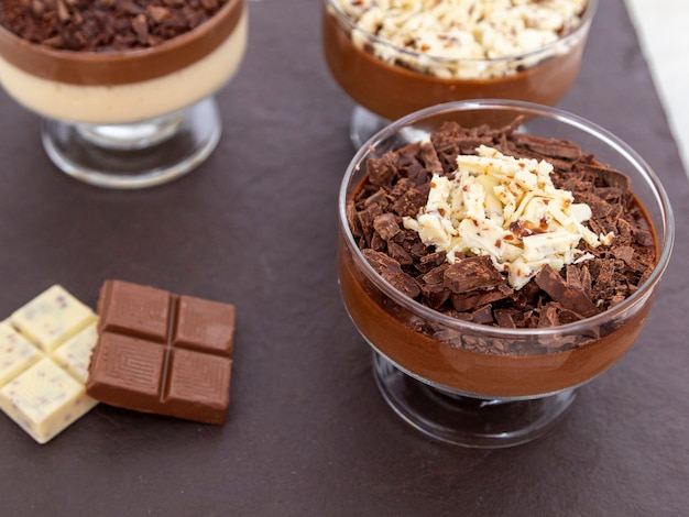 Cup of dessert with milk chocolate mousse with white chocolate shavings