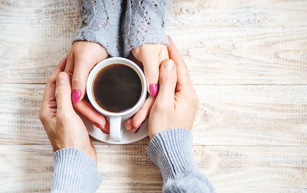 Cup drink for Breakfast in the hands of lovers. Selective focus. 