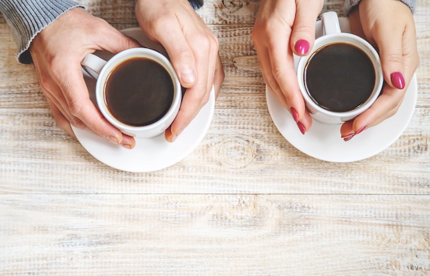 Cup drink for Breakfast in the hands of lovers. Selective focus.