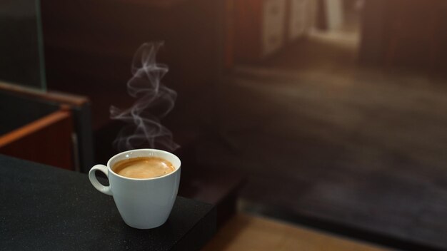 Cup of espresso coffee on black table