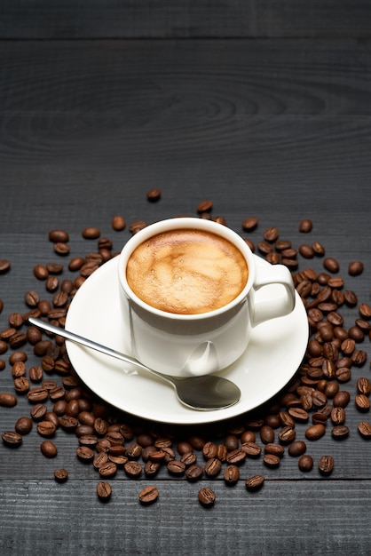 Cup of espresso coffee on dark wooden table