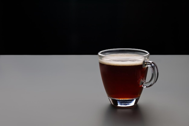 Cup of espresso coffee in glass brew from arabica on dark background Arabica Copy space