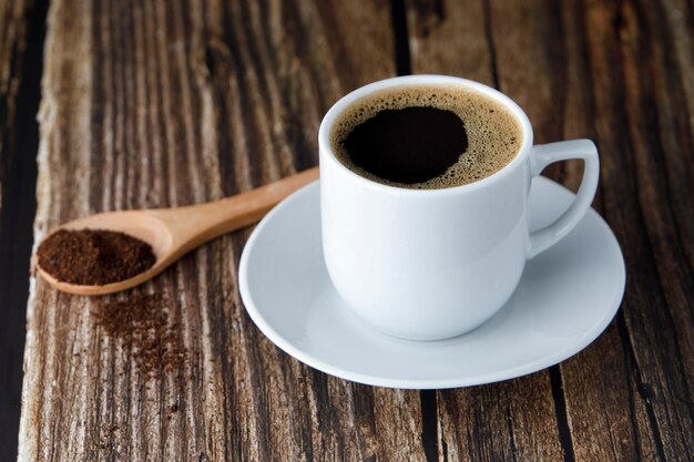 Cup of espresso coffee on wooden table