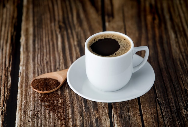 Cup of espresso coffee on wooden table