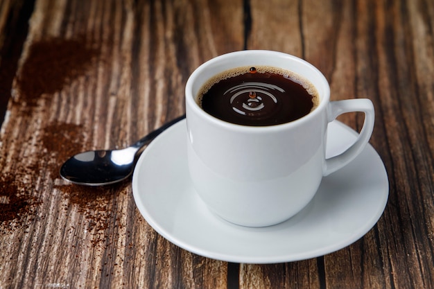 Cup of espresso coffee on wooden table