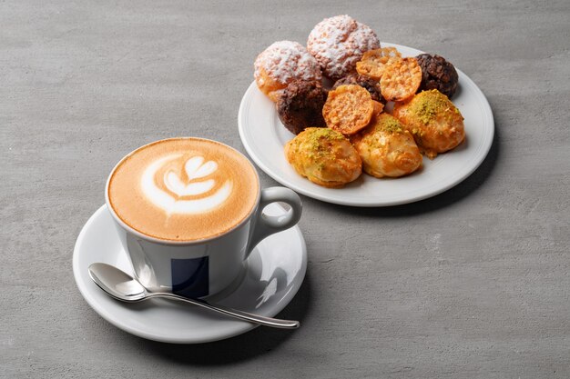 cup of espresso and cookies on a gray table