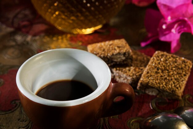 Cup of espresso and sesame almond brittle