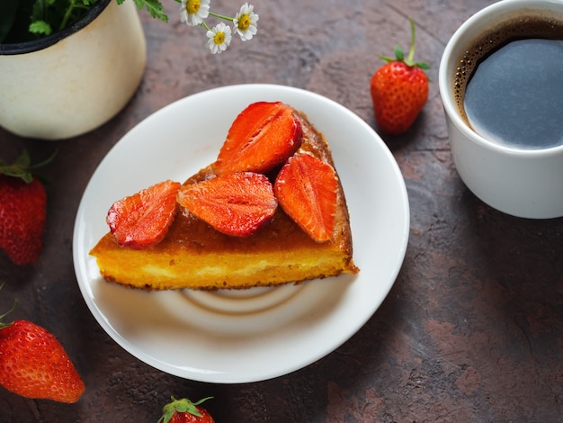 A Cup of espresso and strawberry pie on the table