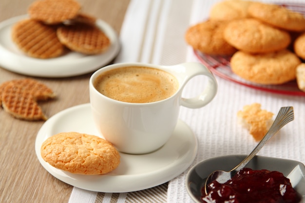 Cup of espresso with coconut cookies on a plate