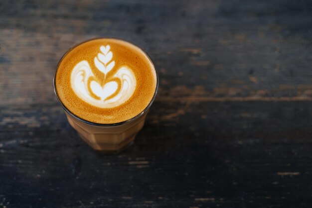 Cup of flat white coffee on a wooden table