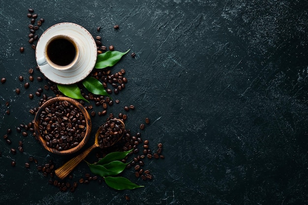 Cup of fragrant black coffee On a black stone background Top view Free space for your text