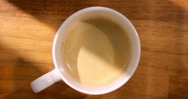 Cup of fragrant coffee on a wooden table