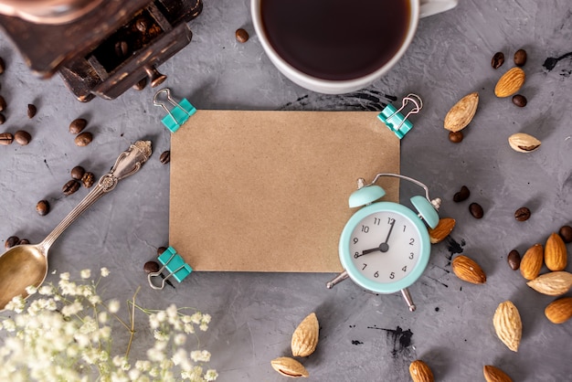 Cup of fragrant morning coffee, an alarm clock, a coffee grinder