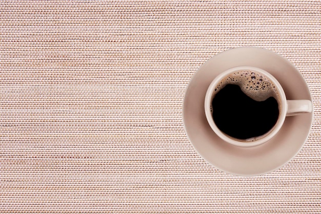 Cup from coffee on saucer on bamboo background