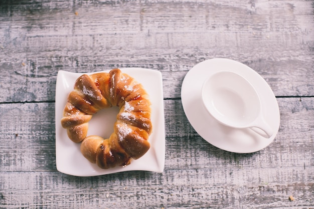 Cup of fruit tea with croissant