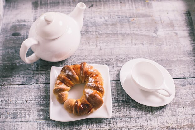 Cup of fruit tea with croissant