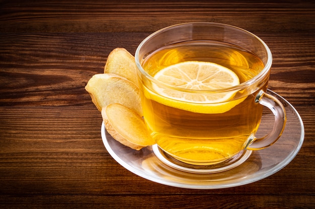 Cup of Ginger tea with lemon and ginger root