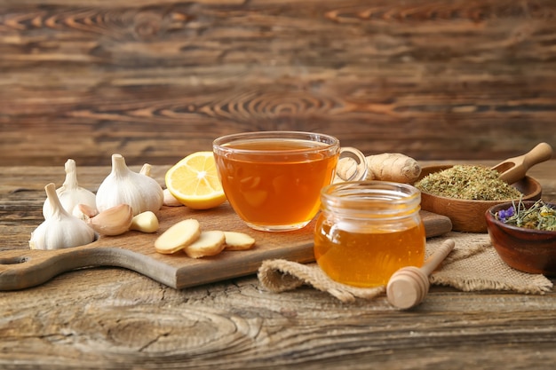 Cup of healthy garlic tea on table