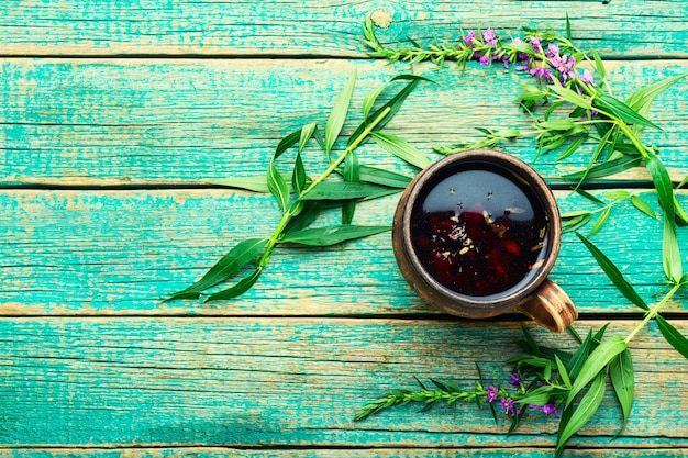 Cup of herbal tea on the table. Ivan tea or fireweed.Willow-herb.Copy space